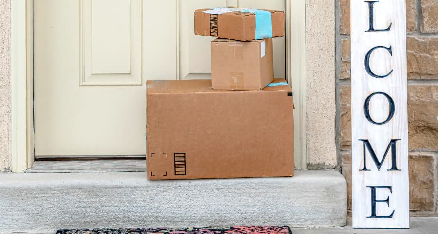 Packages on the doorstep of a home with a welcome sign in Philadelphia